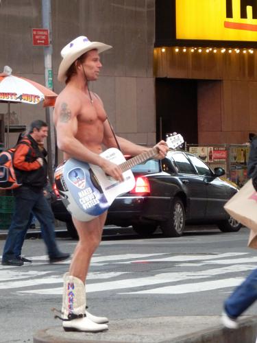 an almost-naked cowboy advertising for Naked Cowboy Oysters in New York City