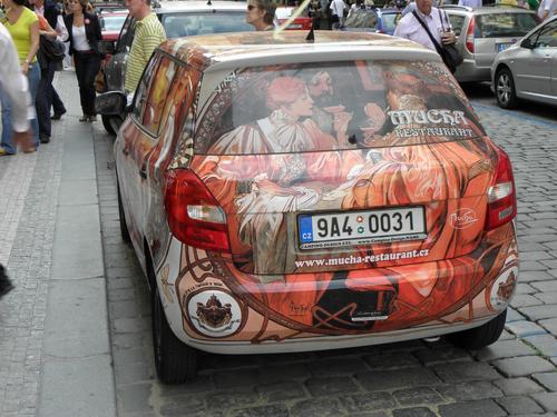 car painted with a Mucha Restaurant advertisement in the Czech Republic