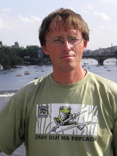 a vendor on Prague's Charles Bridge with a Prague Zoo frog-motif T-shirt in the Czech Republic