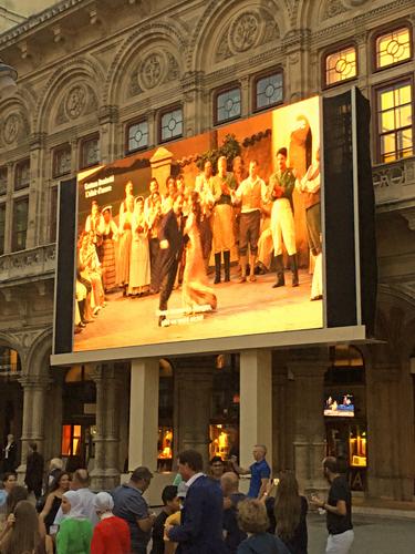 huge movie screen showing live performance at the Vienna State Opera in Vienna, Austria