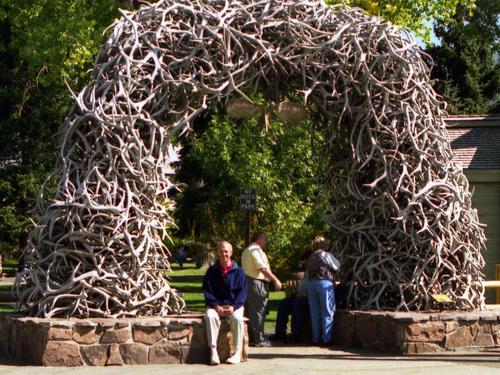 Fred sits under an arch of elk antlers at Jackson Hole near Yellowstone National Park, Wyoming