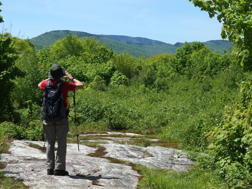 Dick takes a photo of the view from the summit of Bad Mountain in western Maine