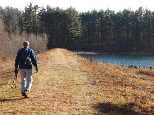 Len walks over the dam on the trail to Bayberry Hill at Leominster, MA