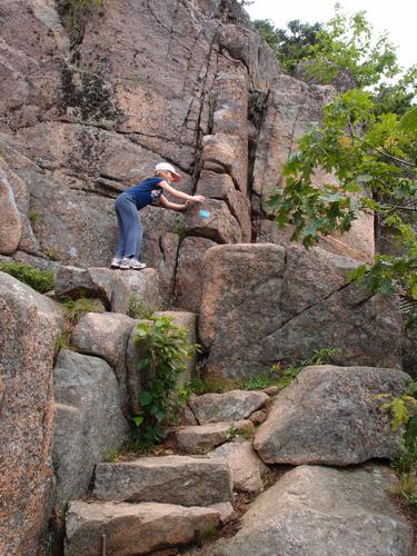 young hiker on the way up the Beehive Trail at Acadia National Park in Maine