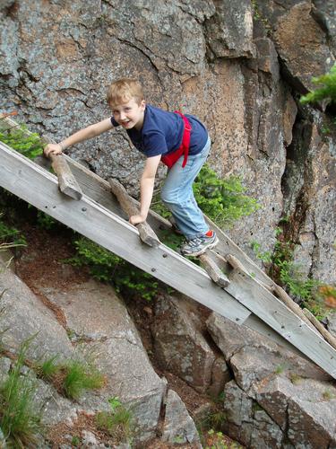 hiker on the Hi-Cannon Trail to Cannon Mountain in New Hampshire