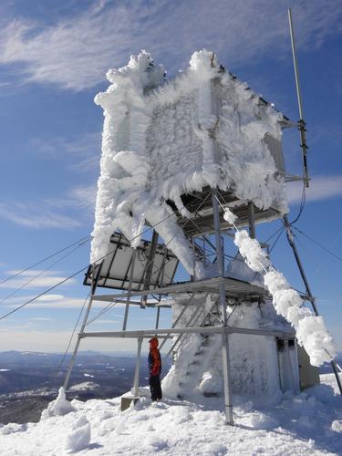 hiker on the summit of Mount Cardigan in New Hampshire