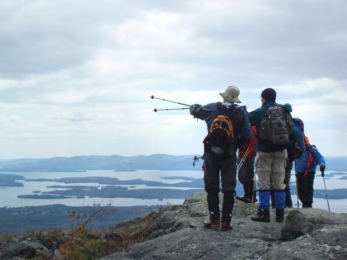 hikers on Mount Roberts ridge overlooking Lake Winnipesaukee in New Hampshire