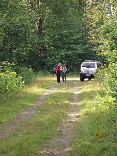 Chuck and Marianne check maps at hike start on the access road to Gore Mountain in northern New Hampshire