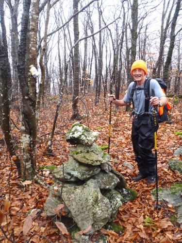 bushwhacker at the summit of Spruce Peak in Vermont