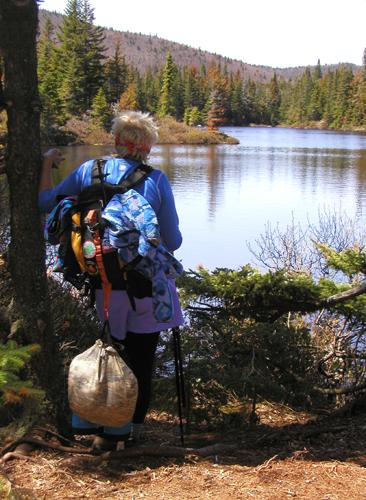 hiker at Unknown Pond in New Hampshire