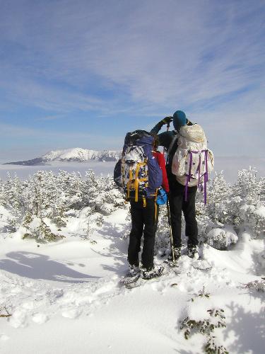 winter view from South Kinsman Mountain in New Hampshire across Franconia Notch with undercast clouds