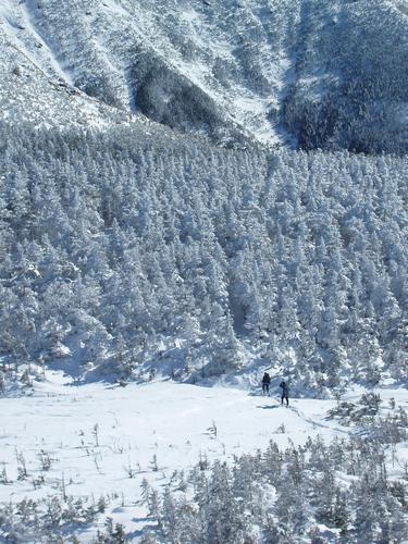 two winter hikers head up from Greenleaf Hut toward Mount Lafayette's summit cone in New Hampshire