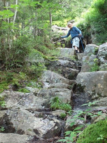 hiker on the Flume Slide Trail to Mount Flume in New Hampshire