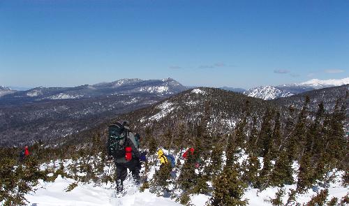 March bushwhackers on Mount Lowell enjoy a fine view of the White Mountains in New Hampshire