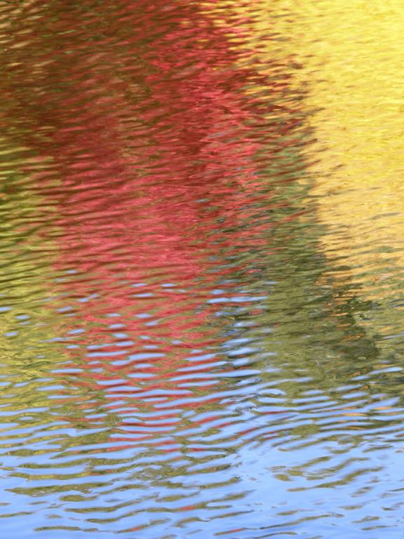 autumn colors reflected off the Nashua River in Mine Falls Park in New Hampshire