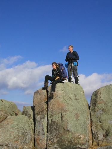 Sarah and Tom climb ridge boulders in November on Moat Mountain in New Hampshire