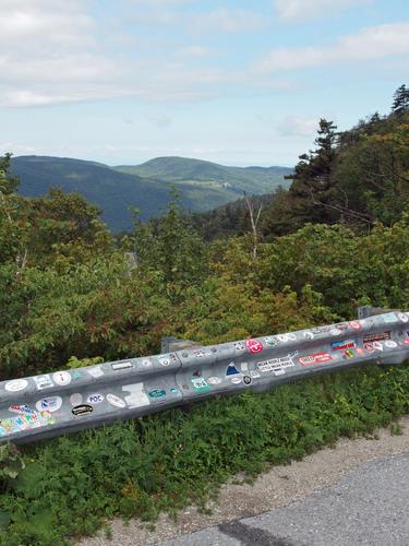 parking-lot guardrail covered with bumper-stickers at Molly Stark Mountain in VT