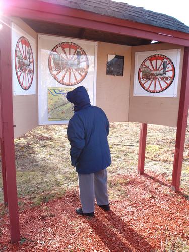 visitor at the kiosk at the west end of the Nashua Heritage Rail Trail in New Hampshire