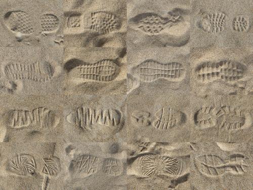 sixteen different footprints in the sand on a winter day at Old Orchard Beach in southern coastal Maine
