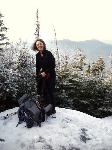 hiker at the summit viewpoint on Mount Passaconaway in New Hampshire