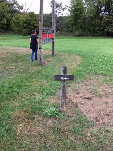 Linda with spinning prayer wheels in the Hope section at Path of Life Garden at Windsor in eastern Vermont