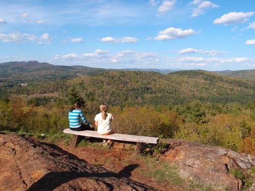 hikers on the summit of Little Round Top near Newfound Lake in New Hampshire