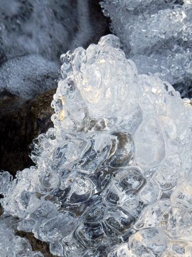 river ice beside the trail to Shelburne Moriah Mountain in New Hampshire