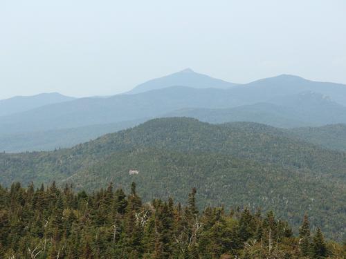 view of Molly Stark Mountain (near bump) and Camel's Hump (far pointy peak) 
from the panorama viewpoint on Stark Mountain in northern Vermont