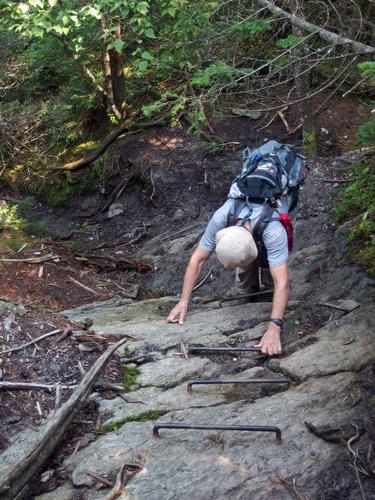 Dick descends metal rungs on a steep section of the Long Trail on Stark Mountain in northern Vermont