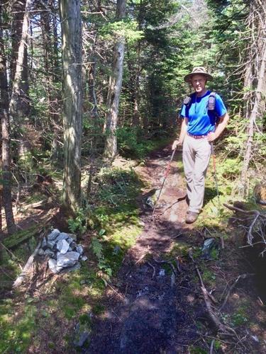 Fred stands by the summit cairn on Stark Mountain in northern Vermont