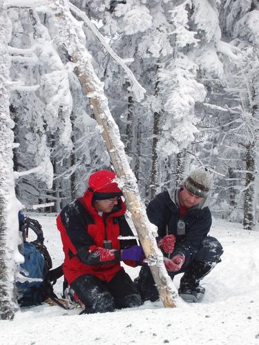 two hikers checking the sign on Goback Mountain in New Hampshire