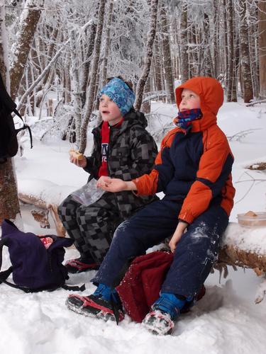 hikers enjoying a lunch stop on the trail to Mount Tom in New Hampshire