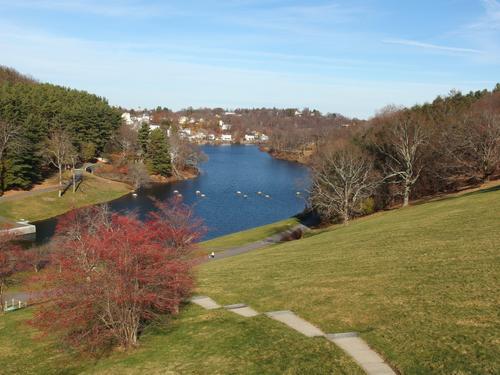 view from the edge of Wachusett Reservoir dam down to the Nashua River below and the distant town of Clinton, Massachusetts