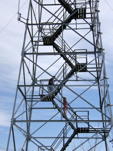 hikers part way up the fire tower on Wachusett Mountain in Massachusetts