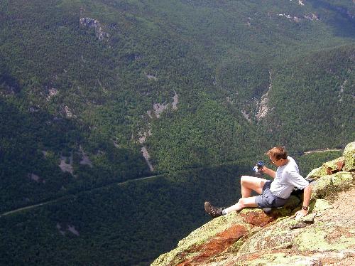 hiker on the edge of Mount Webster in New Hampshire