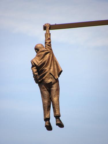 the Hanging Man modern-art statue above the street at Prague in the Czech Republic