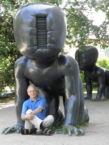  tourist at one of the computer-faced toddler statues outside the Kampa Museum at Prague in the Czech Republic